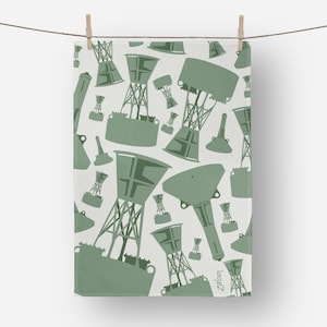 May include: A white towel with a repeating pattern of green buoy illustrations. The towel is hanging from a clothesline with wooden clothespins. The design includes various buoy shapes and sizes.