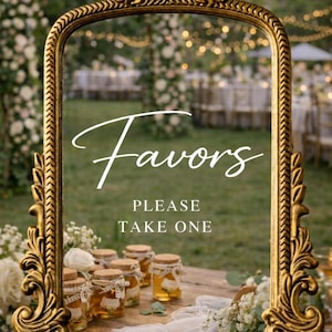 May include: A gold-framed sign with the word "Favors" in elegant script, with the text "PLEASE TAKE ONE" below. Small jars of honey with decorative twine and corks are displayed on a wooden table.