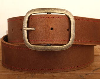 May include: A brown leather belt with a red stitched edge and a brass buckle.