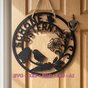 May include: Black laser-cut wooden Easter sign with the words "Schöne Ostern", two birds, a carrot, and floral accents. The sign is round and hangs from a rope. The sign is hanging on a wooden door.