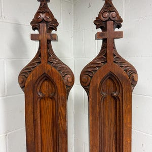 Pair of antique 1800s Gothic revival carved wood church cross sculptures pew end