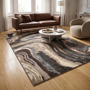 May include: A rectangular area rug featuring a swirling, marbled pattern in shades of dark brown, charcoal gray, cream, and beige. The rug has a low-pile texture and is positioned on a light-toned wooden floor, covering a large portion of the space.