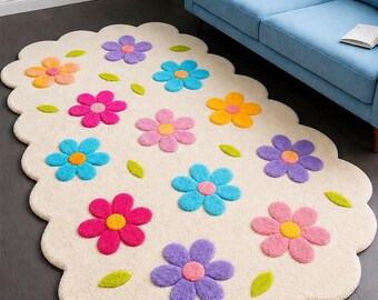 May include: An off-white area rug with a scalloped edge featuring a repeating pattern of tufted flowers in shades of purple, blue, pink, orange, and yellow, interspersed with small green leaves across the entire surface of the rectangular rug.