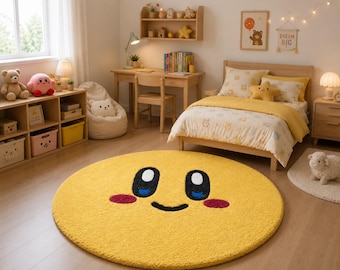 May include: A circular yellow area rug featuring a cartoon face with large black and blue eyes, a small black smile, and two pink oval cheeks. The rug has a textured, plush surface and is positioned on a light-colored wooden floor in a bedroom.