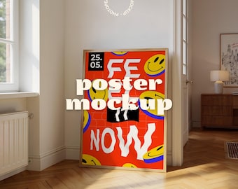 May include: A framed poster mockup with a red background and yellow smiley faces. The poster has the words "FE", "poster mockup", and "NOW" in white. The date "25. 05." is in the upper left corner. The frame is a light brown color.
