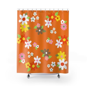 May include: Orange shower curtain with a repeating floral pattern. The flowers are in various colors, including white, red, yellow, pink, and brown, with green leaves. The curtain is hanging from a metal rod.