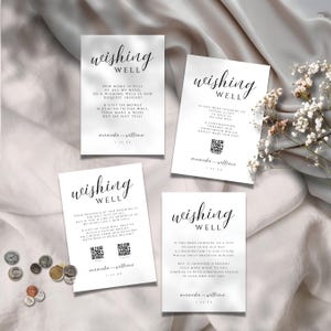 May include: Four white cards with the words "Wishing Well" in elegant script. Each card has a different message about gifts, with names and a date at the bottom. Coins are scattered near one card.