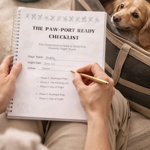 May include: A checklist titled "The Paw-Port Ready Checklist" for domestic flight travel with a dog named Buddy. A person is writing on the checklist with a gold pen. A dog carrier and a teal pet bowl are in the background. The text "Using the guide in action" is at the bottom.