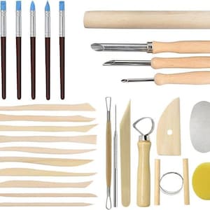 May include: A collection of pottery tools, including brushes with blue tips, wooden modeling tools, and metal sculpting tools. The set also includes a sponge and wire tools, ideal for various clay projects.