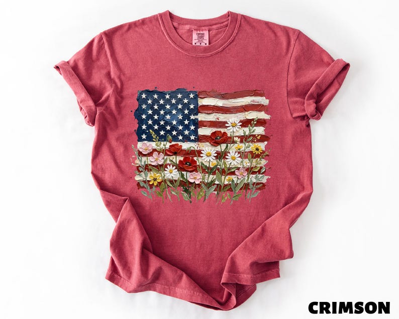 A red t-shirt with an American flag design and colorful flowers printed on it.