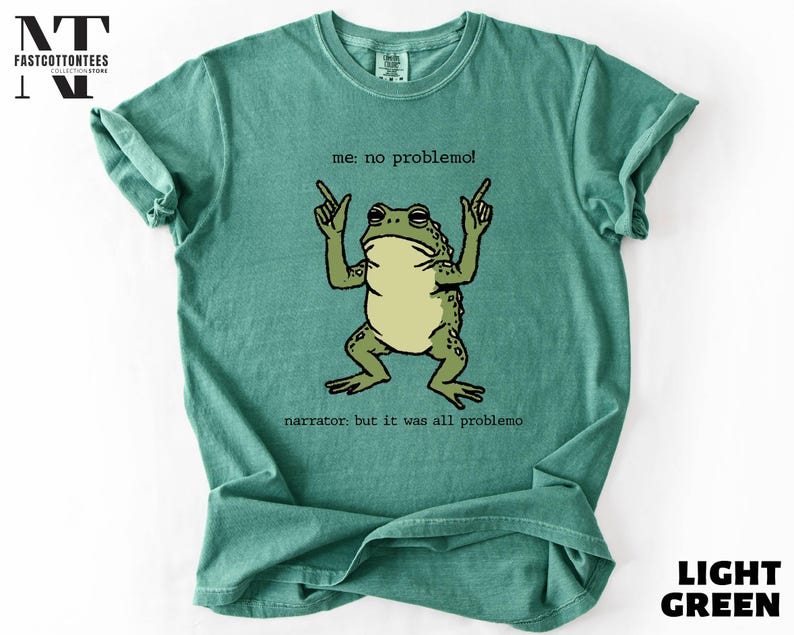 a green t-shirt with a cartoon frog and text printed on it.
