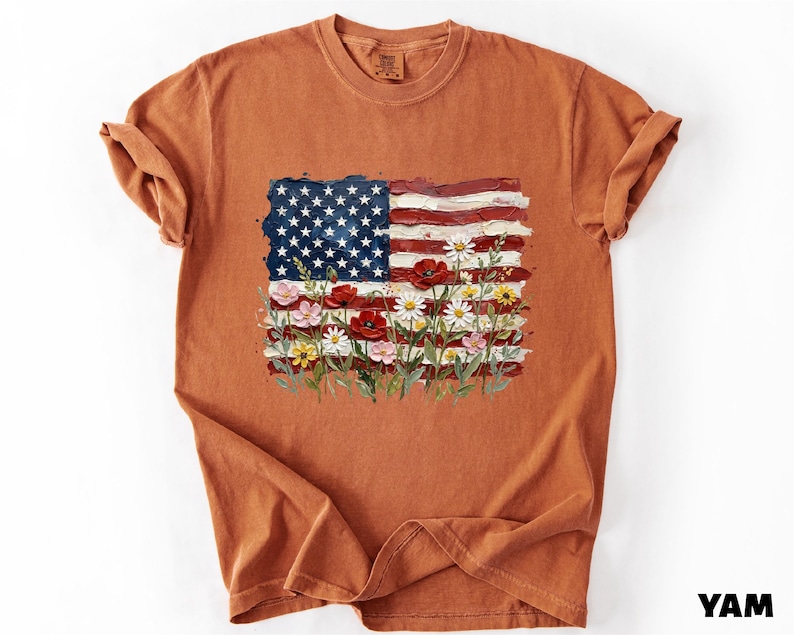 a brown t-shirt with a design of the American flag and flowers.