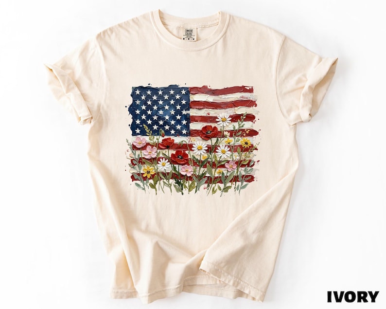 A white t-shirt with a graphic design depicting the American flag and flowers.