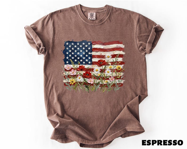 A brown t-shirt with an American flag design and colorful flowers printed on it.