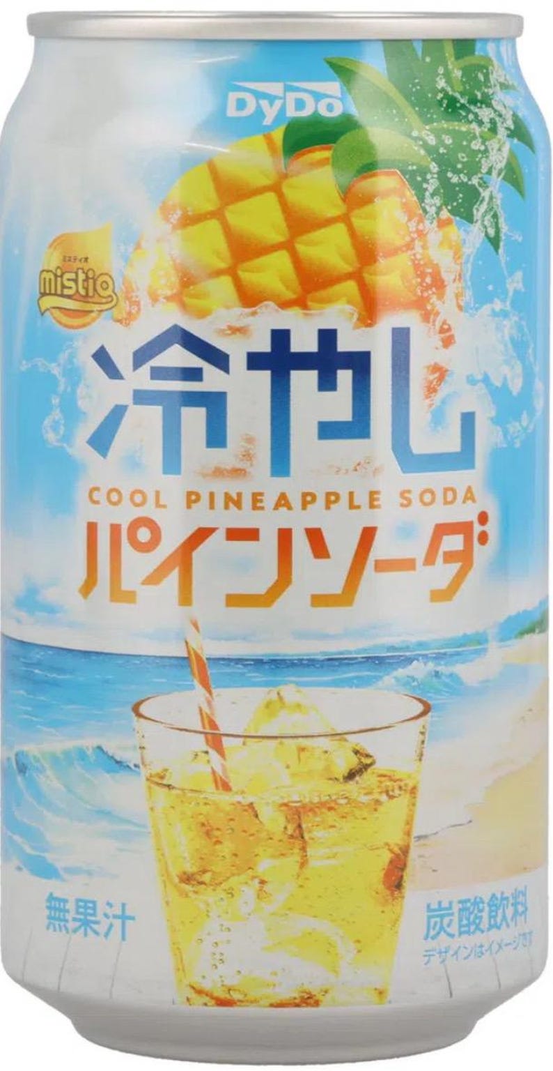 May include: A can of DyDo Mistio Cool Pineapple Soda. The can features a vibrant illustration of a pineapple and a glass of soda with a straw. Japanese text is visible on the can.