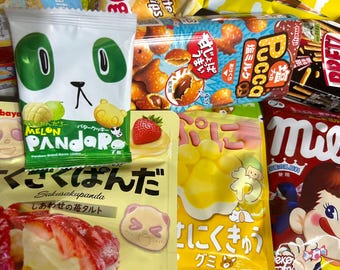 May include: A selection of Japanese snacks, including panda-shaped biscuits, strawberry tarts, and gummy sweets. The packaging is brightly coloured with cartoon characters and Japanese text, offering a variety of treats.