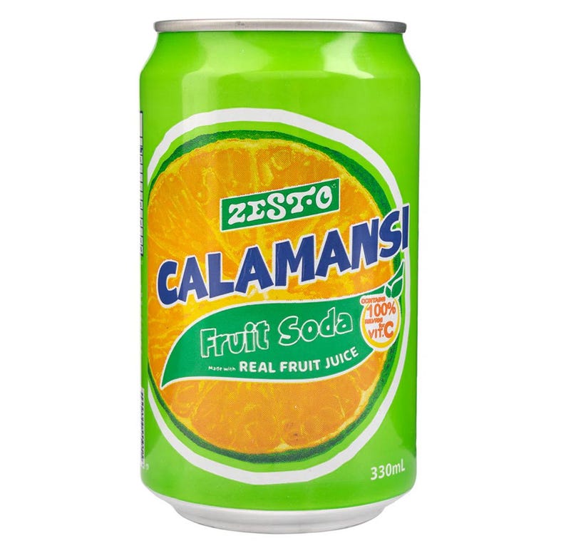 May include: A green Zesto Calamansi Fruit Soda can with an orange slice graphic. The can features the text "CALAMANSI Fruit Soda" and "Made with REAL FRUIT JUICE". The can also states it contains 100% of the daily value of Vitamin C. The can contains 330ml of liquid.
