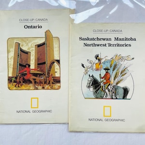 May include: Two National Geographic Close-Up: Canada booklets. The left booklet features Ontario with a city illustration. The right booklet features Saskatchewan, Manitoba, and Northwest Territories with an illustration of a mounted officer.