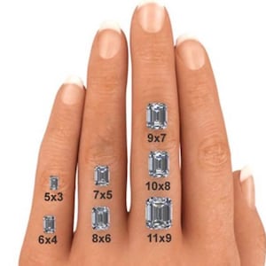 May include: A hand displaying various emerald-cut diamond sizes. The sizes are labeled: 5x3, 6x4, 7x5, 8x6, 9x7, 10x8, and 11x9. The diamonds are clear and sparkling, showcasing their rectangular shape.