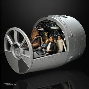 May include: A detailed model of the Millennium Falcon cockpit from Star Wars. The interior features figures of Han Solo, Chewbacca, C-3PO, and Princess Leia. The cockpit is a light gray color with detailed control panels and a circular window.