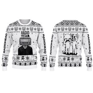 May include: A white long-sleeve jumper featuring a black graphic print. The front displays a person with a radio for a head and the text RADIOHEAD. The back shows two cartoon characters. Both sides feature patterns of snowflakes, skulls, and trees.