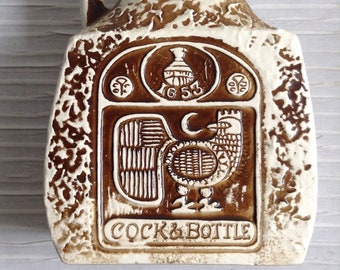 Cock & Bottle decanter. Knights Arms reverse.  Vintage 1960 Ceramic.  White and bronze Lava Style Glaze.  Made in Japan.  Enesco label.