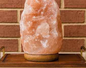 Himalayan large salt rock lamp with wood base .Natural pink color warm amber glow .