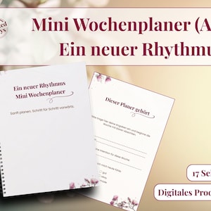以下が含まれることがあります： ブルゴーニュ色の「Mini Wochenplaner (A5) Ein neuer Rhythmus」というテキストが入った、白いスパイラル綴じのプランナー。開いたプランナーには罫線入りのページと花のアクセントが示されています。「Digitales Produkt」というテキストも表示されています。
