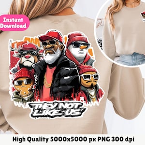 Op de afbeelding: Beige sweatshirt met een afbeelding van vier cartoonfiguren met zonnebrillen en rode hoeden. De afbeelding bevat een rendier, een sneeuwpop en een peperkoekmannetje. De tekst "THEY NOT LIKE US" staat onder de karakters. Een kleinere afbeelding van een kerstman staat rechtsboven.