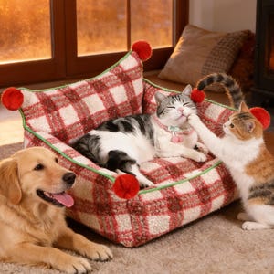 May include: A cozy pet bed with a red and white plaid pattern, accented with red pom-poms. A gray and white cat relaxes in the bed, while a golden retriever and a calico cat are nearby. The bed has a green trim.