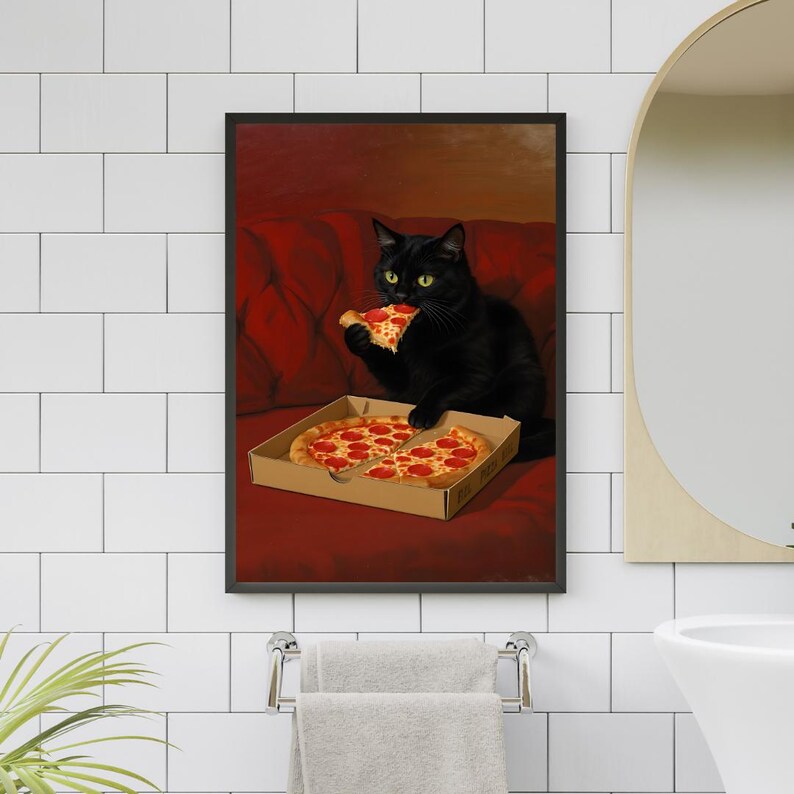 May include: A framed print featuring a black cat enjoying a slice of pizza from a cardboard box. The cat is sitting on a red couch. The pizza has pepperoni toppings.