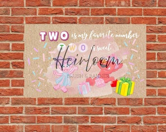 May include: A rectangular banner with the text "TWO is my favorite number" and "TWO is sweet Heirloom". The banner features cartoon characters, confetti, and gift boxes. The background is a brick wall.