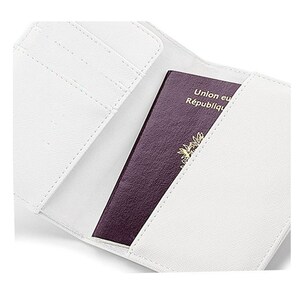 May include: White passport holder with a burgundy passport inside. The passport has the text "Union europ&eacute;enne R&eacute;publique fran&ccedil;aise" on the cover.