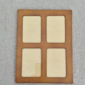 May include: A rectangular, four-opening photo frame with a warm brown finish. The frame has four rectangular openings for photos, each with a light beige backing. The frame is made of a sturdy material and is suitable for displaying multiple photos.