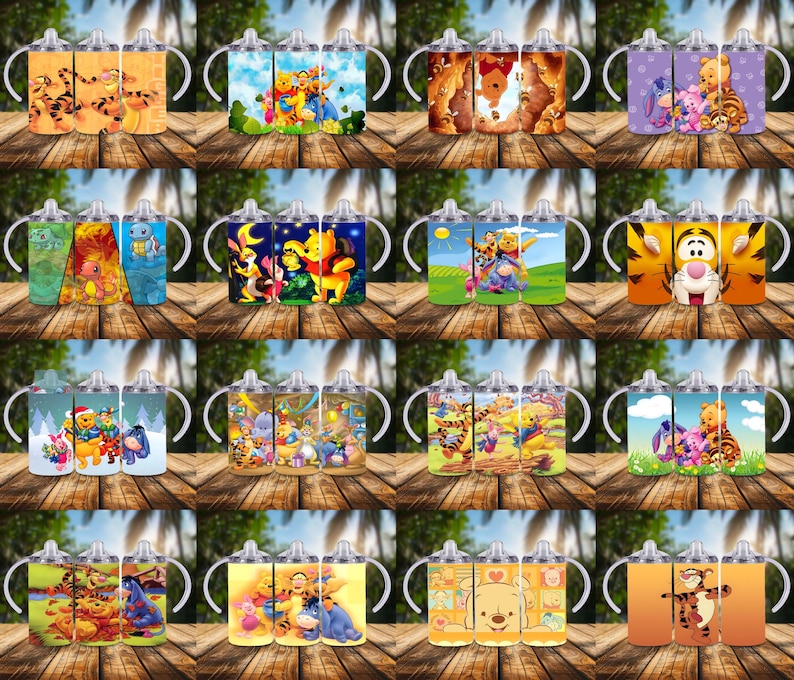 May include: A collection of colorful sippy cups featuring various characters from the Winnie the Pooh franchise. The cups have white handles and lids, with images of Pooh, Tigger, and friends. The cups are displayed on a wooden surface.