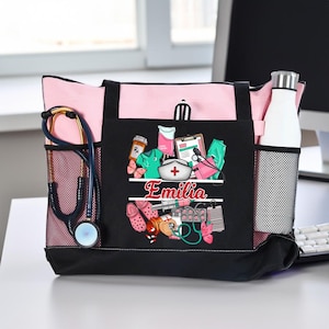 May include: A pink and black tote bag featuring a black front pocket with a graphic print of medical supplies, including a nurse cap, stethoscope, and syringe, with the name Emilia printed in red. A stethoscope is tucked into the side mesh pocket.