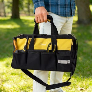 May include: Black and yellow tool bag with multiple pockets and a shoulder strap. The bag has a yellow top section and the name "James" embroidered on the front. Tools are visible in the side pockets.