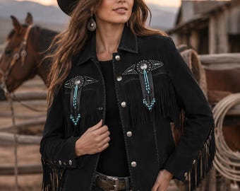May include: A black jacket featuring long fringe detailing on the chest and sleeves, accented with silver-toned concho buttons and turquoise bead embellishments. The garment is worn with a black cowboy hat and a dark brown textured belt.