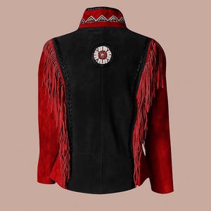 May include: A black and red suede jacket with fringe and decorative beading. The jacket has red sleeves and fringe, a black back panel, and a beaded collar. A circular beaded design is centered on the back.