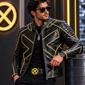 May include: Black leather jacket with yellow detailing and a matching belt with a yellow emblem. The jacket has a quilted design and a zip closure. The person is wearing black trousers and sunglasses.