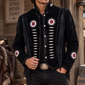 May include: A black jacket featuring long fringe along the shoulders and sleeves, decorated with white and red circular embroidery patches and vertical white bone-like accents. The jacket has a high collar, silver buttons, and a black cowboy hat.