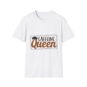 May include: White t-shirt with the text "Caffeine Queen" in a black outlined rectangle. The word "Queen" is in a leopard print pattern, and a black crown sits above the word "Caffeine".