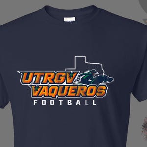 May include: Navy blue t-shirt featuring the text "UTRGV VAQUEROS FOOTBALL" in orange, white, and gold. The design includes a Texas outline and a graphic of a football player in green and blue.