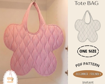 May include: A quilted flower-shaped tote bag with pink and white vertical stripes, hanging from a metal hook. The image includes text: Flower Tote BAG, ONE SIZE, PDF PATTERN, BEGINNER FRIENDLY, instant download, and a Minihands Lab logo.