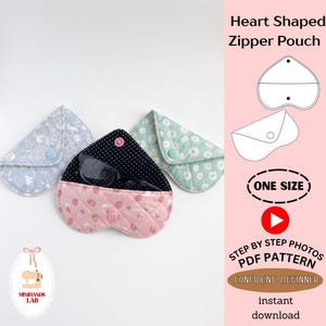 May include: Three heart-shaped quilted pouches with snap closures. One is light blue with white floral patterns, one is mint green with white daisies, and one is pink with strawberries and a black polka dot interior holding black eyeglasses.