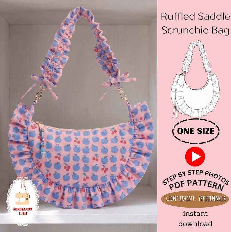 May include: A pink saddle bag with a repeating blue apple and red cherry pattern, featuring a ruffled edge and a gathered scrunchie-style shoulder strap with small side bows. The bag includes a zipper closure with a small beaded pull tab.