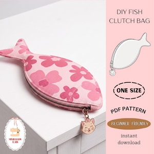 May include: A pink fish-shaped clutch bag with a floral pattern and a zipper closure. The bag has a cat charm attached to the zipper. The text "DIY FISH CLUTCH BAG", "ONE SIZE", "PDF PATTERN", "BEGINNER FRIENDLY", and "instant download" are also visible.