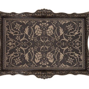 Pode incluir: Bandeja decorativa retangular com padr&atilde;o floral e de folhas ornamentado em cor bronze escuro. A bandeja tem al&ccedil;as integradas e uma borda detalhada. A superf&iacute;cie apresenta um design floral repetido.
