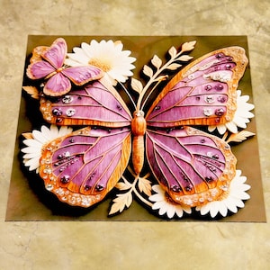 May include: A wooden butterfly sculpture with purple and orange wings, embellished with rhinestones. The butterfly is set amongst white daisies and leaves, on a dark green square background. A detailed piece of art.