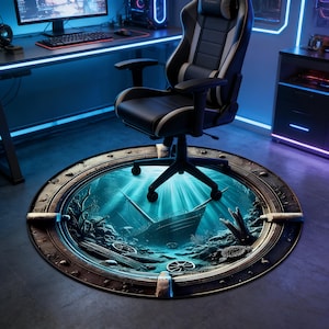 May include: A black and grey gaming chair on a round rug featuring an underwater shipwreck scene. The rug has a metal frame and depicts a sunken ship, coral, and marine life in shades of blue and green, creating a 3D effect.